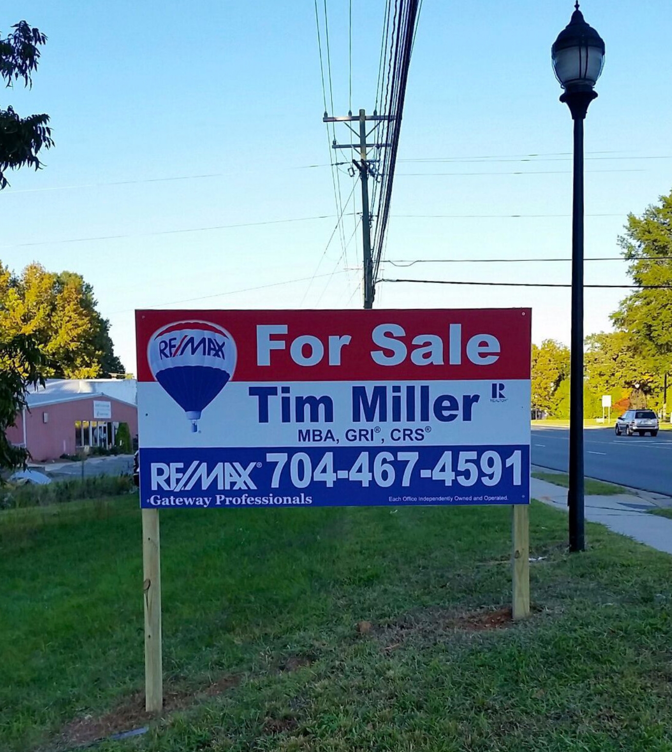 A real estate for-sale Panel sign by REMAX featuring agent Tim Miller