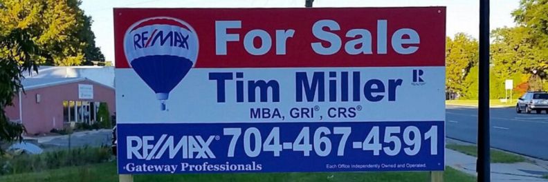 A real estate for-sale Panel sign by REMAX featuring agent Tim Miller_